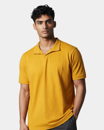 Man wearing a yellow polo shirt against a gray background