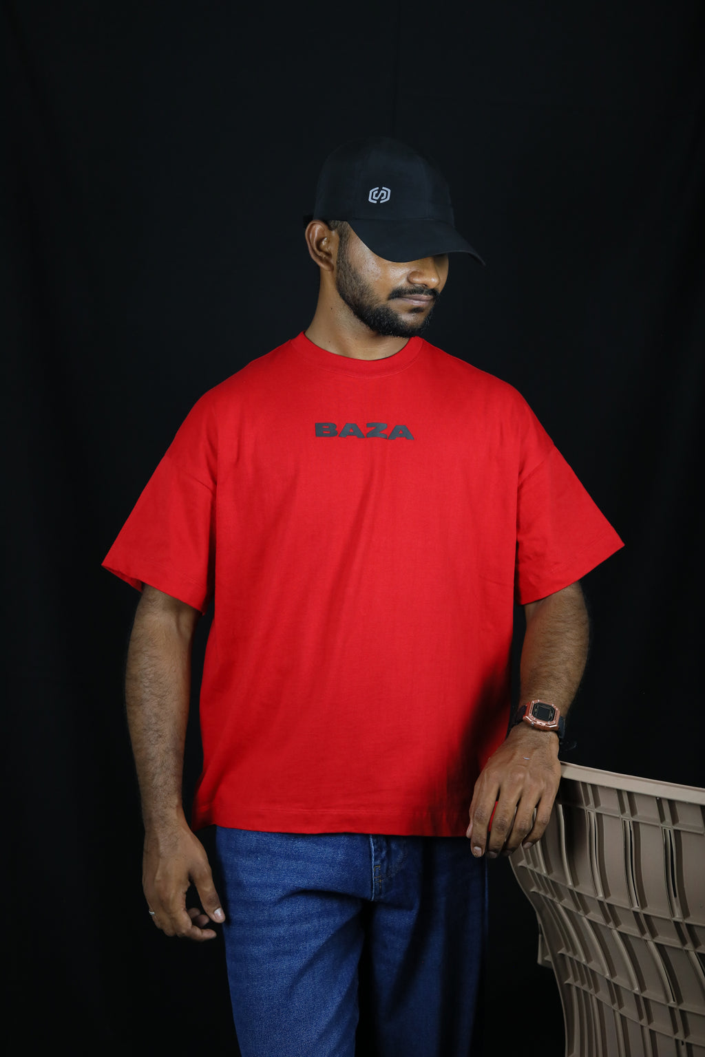 Person wearing a red shirt with 'Bally' branding on a black background